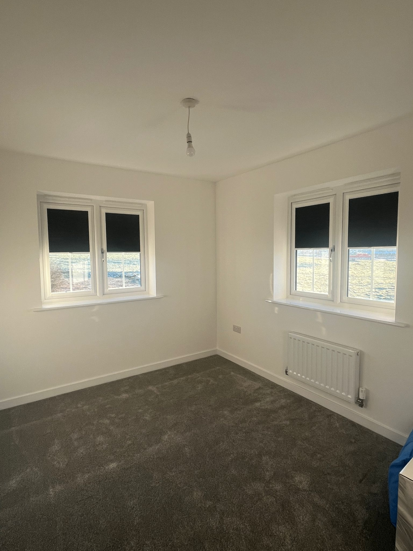 Black Perfect Fit blackout blinds fitted to two bedroom window pairs