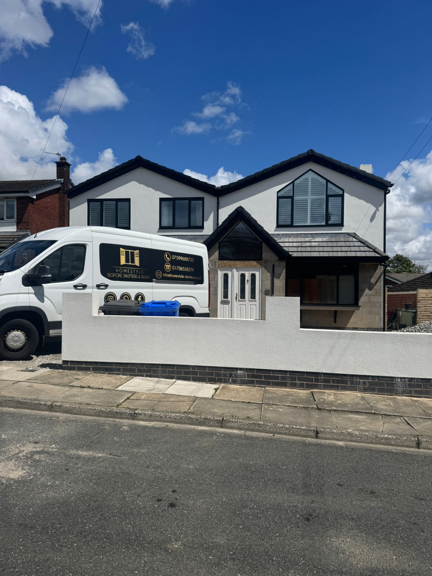 Exterior of a home showing shaped shutters fitted in upper-floor gable and standard windows